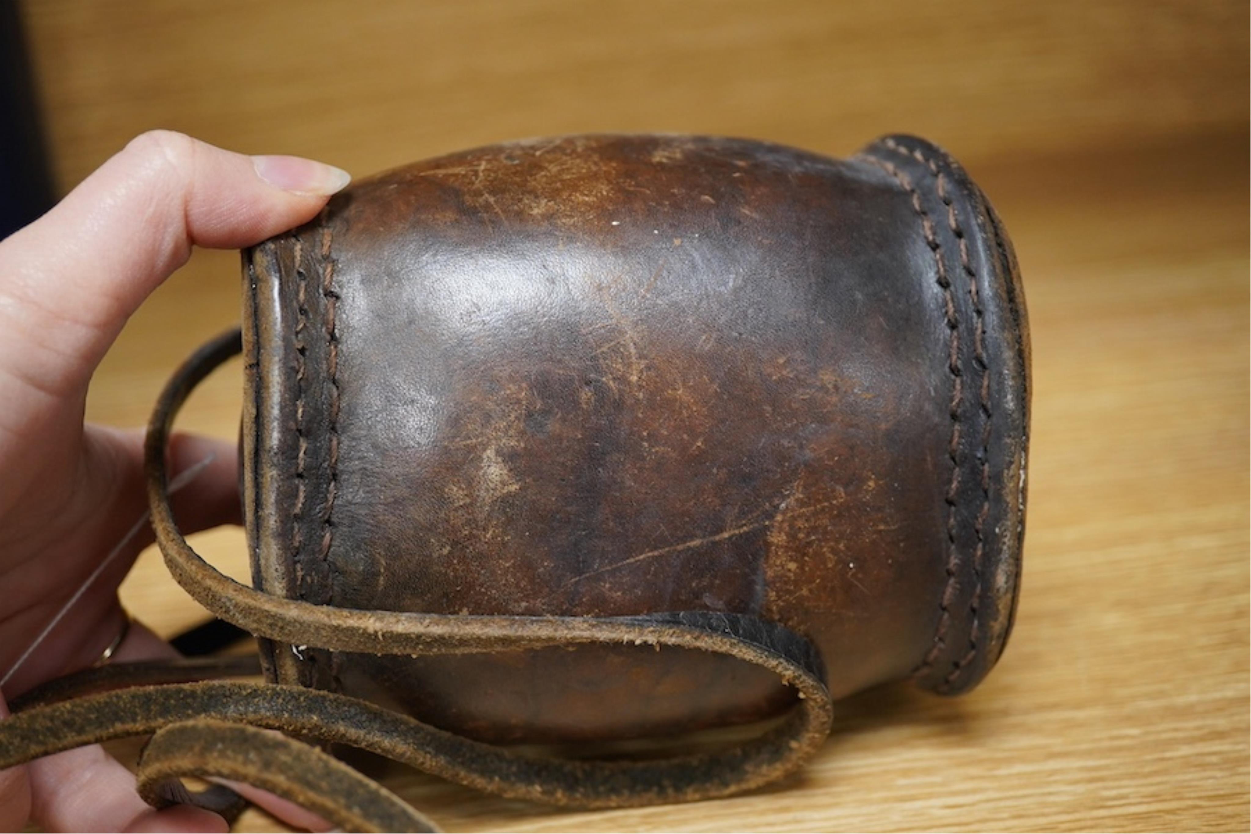 A leather cider costrel, 14cm wide. Condition - fair, some scuffing